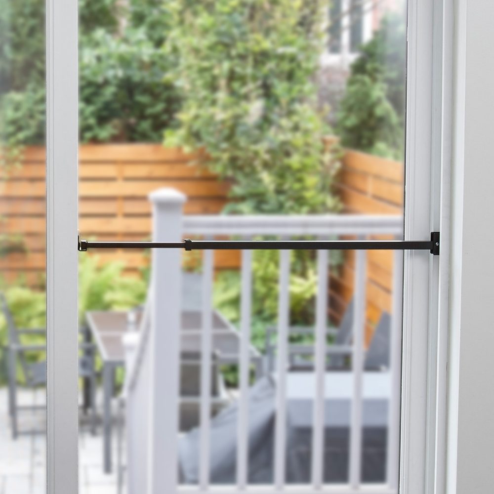 The Ideal Security patio door security bar, locked in place to prevent intruders from sliding open a patio door.